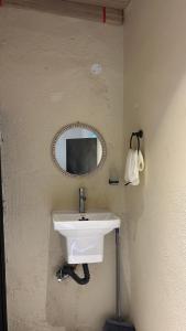 a bathroom with a sink and a mirror on the wall at Seet Room in Bilād Sayt