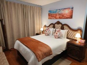 a bedroom with a large bed with white sheets and pillows at Golden Sun Refugio -Calheta in Estreito da Calheta +36 photos