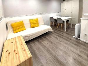 a living room with a couch and a table at Loft 4 personas en La Molina in La Molina