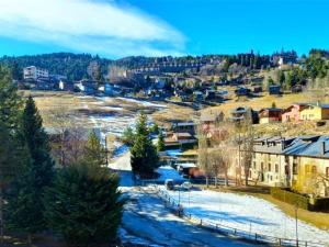 a small town with snow on the ground and buildings at Loft 4 personas en La Molina in La Molina +10 photos