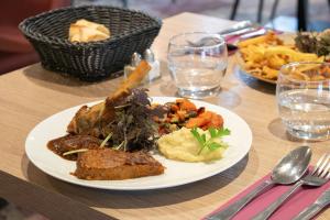 a table with a plate of food on a table at Brit Hotel Brest Le Relecq Kerhuon in Le Relecq-Kerhuon +52 photos