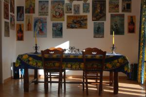 a dining room table with two chairs and a blue table cloth at Villa Aghjanella in Patrimonio +19 photos
