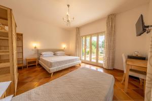 a bedroom with two beds and a table and a desk at Villa Carlotta Resort in San Leone +146 photos