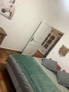 a bedroom with a bed with a horse on the wall at Gite Armieux in Saintes-Maries-de-la-Mer