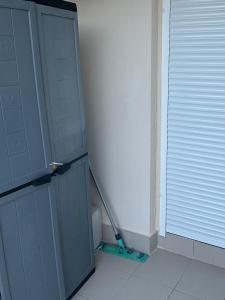 a bathroom with a toilet and a door with a mop at Le Cocoon Elite in Beynost