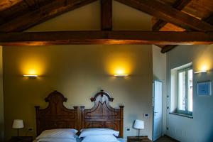 a bedroom with a bed with a wooden head board at Ca'Rapulin in Calosso