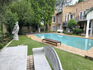 a swimming pool in the yard of a house at Waterfall City Guest Lodge in Sandton