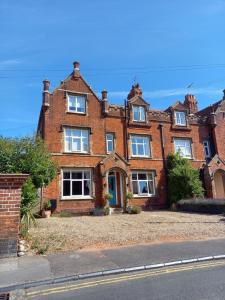 a large red brick house on the side of a street at No4 Cromer in Cromer