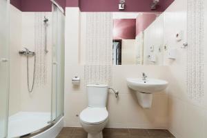 a bathroom with a toilet and a sink and a shower at Hotel Pod Kasztanami in Lublin