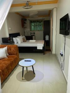 a living room with a couch and a bed at Bliss Residence Studio Mtwapa in Mtwapa