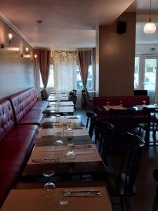 a row of tables in a restaurant with wine glasses at New SAMANKE in Floirac