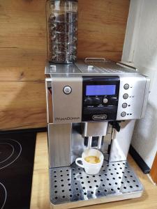 a coffee machine with a cup of coffee at Apartmani LIDER Visoko in Visoko