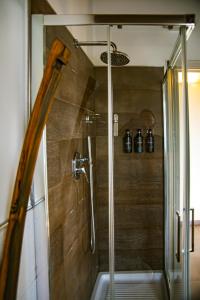 a shower with a glass door in a bathroom at Ca'Rapulin in Calosso +64 photos