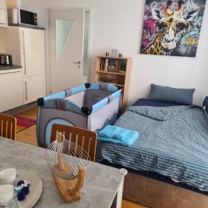 a living room with two beds and a table at Apartment „Am Südhang“ in Adelzhausen