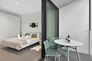 a bedroom with a bed and a table and chairs at Urban Heights - Apartment in St Julian's in St. Julianʼs +48 photos