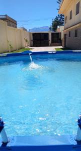 a swimming pool with a water fountain at Luxury Villa, 3 Levels, 5 bedrooms, 5 Baths, Pool & Garden in Tétouan