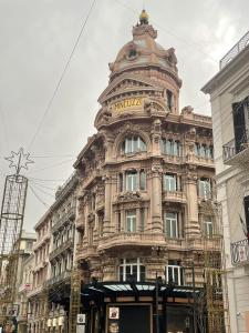 a large building with a tower on top of it at La Maison De Poupée in Bari