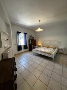 a bedroom with a bed and a tiled floor at Ellie's Kantanos in Kántanos