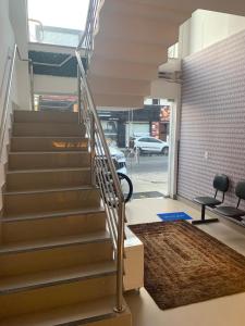 a staircase with a metal handrail in a building at Pousada Pergentino in Maceió