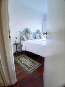 a room with two beds and a door open at Casa Kilowatt - Amarante in Amarante