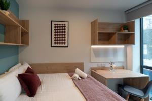 a small bedroom with a bed and a desk at Queen Street Place in Galway