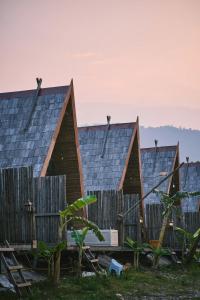 a row of houses with their roofs at Vangvieng Angsavanh Resort in Vang Vieng