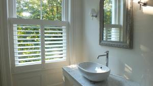 a white bathroom with a sink and a window at Bear's Well Bed & Breakfast in Deal
