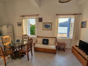 a living room with a table and a couch at Kapsali Beach House in Kapsali