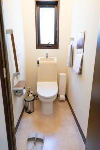 a small bathroom with a toilet and a window at Fuji Life House in Fuji +41 photos