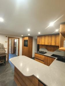 a kitchen with wooden cabinets and a white counter top at Casa Soraya 2 in Falcade