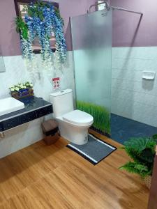 a bathroom with a toilet and a shower at 9 Home Phuket in Ban Rangeng