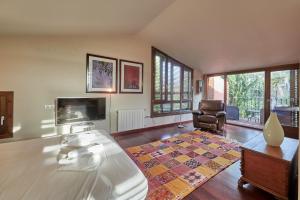 a large living room with a table and a chair at LuxRural Montserrat | Piscina con Vistas Únicas in Marganell +42 photos