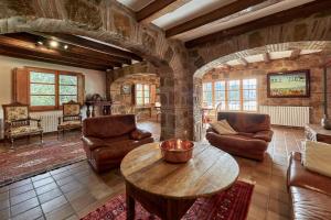 a large living room with a table and chairs at LuxRural Montserrat | Piscina con Vistas Únicas in Marganell