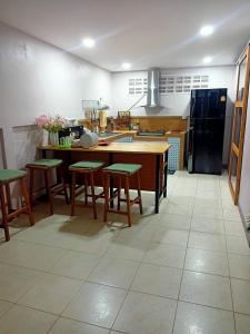a kitchen with a table and some chairs in it at 9 Home Phuket in Ban Rangeng +13 photos