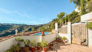 a villa with a swimming pool and a fence at Las Huertas 12 in Frigiliana