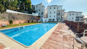 a swimming pool in front of a building at Las Huertas 12 in Frigiliana