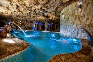 a pool in a cave with blue water at Coto del Valle de Cazorla in Cazorla