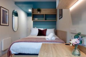 a bedroom with a bed and a wooden table at Queen Street Place in Galway