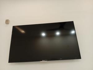 a flat screen tv sitting on a white wall at Private & Cozy 2 & 3 Bedroom Full Apartment for Families, Couples & Solo Near Islamabad Airport in Islamabad