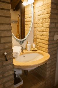 a bathroom with a sink and a mirror at La Locanda del Loggiato in Bagno Vignoni +45 photos