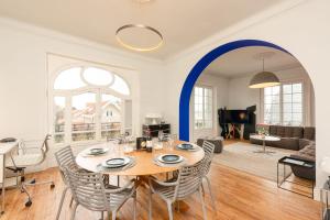a dining room and living room with a table and chairs at MISVA KEYWEEK Architect-designed flat in Biarritz with garden in Biarritz