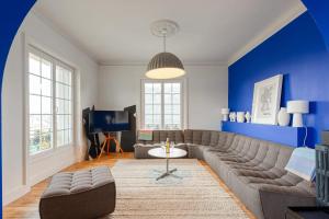 a living room with a couch and a tv at MISVA KEYWEEK Architect-designed flat in Biarritz with garden in Biarritz