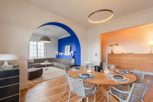 a dining room and living room with a table and chairs at MISVA KEYWEEK Architect-designed flat in Biarritz with garden in Biarritz