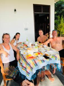 a group of people sitting around a table with food at Moonlit serenity Tangalle in Tangalle +105 photos