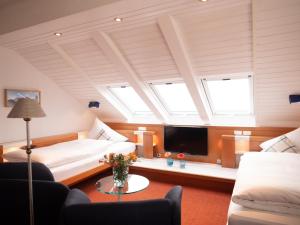 a living room with a couch and a tv at Hanseat in Helgoland