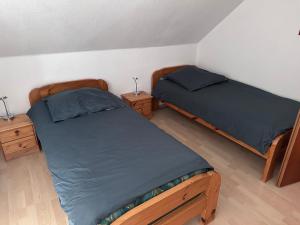 a bedroom with two beds and two night stands at Apel Apartments 2 in Nörten-Hardenberg