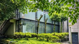 a building with glass windows and plants in front of it at Minami Hakone Villa in Kannami +66 photos