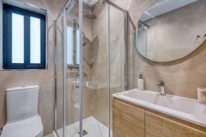 a bathroom with a toilet and a sink and a mirror at Seafront 3 Bedroom Luxury Getaway in St. Paul's Bay +34 photos