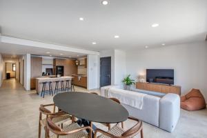 a living room with a couch and a table at Seafront 3 Bedroom Luxury Getaway in St. Paul's Bay