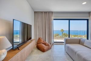 a living room with a couch and a large television at Seafront 3 Bedroom Luxury Getaway in St. Paul's Bay